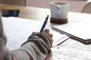 person-writng-on-paper