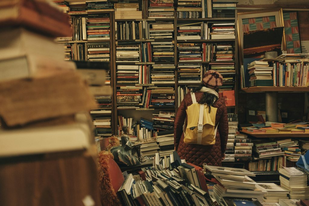 men standing with a lot of books