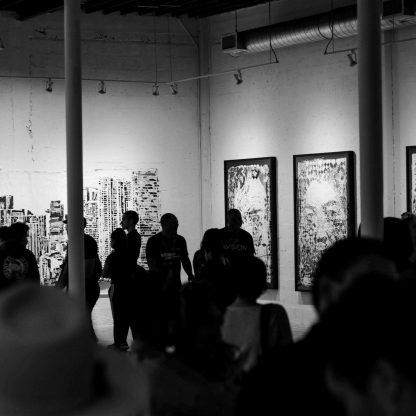 people looking to paintings on the wall