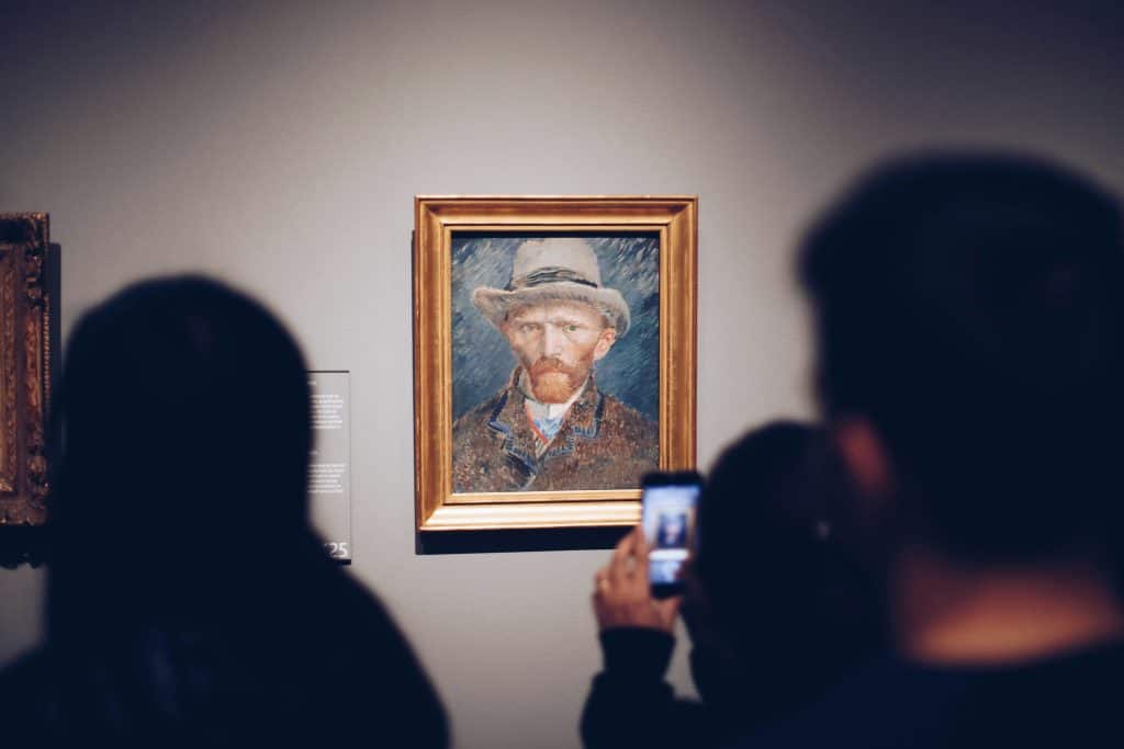 people looking on paintings