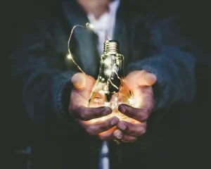 artist-man-holding-light-bulb