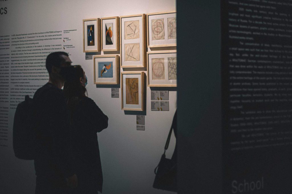 girl and boy looking on paintings