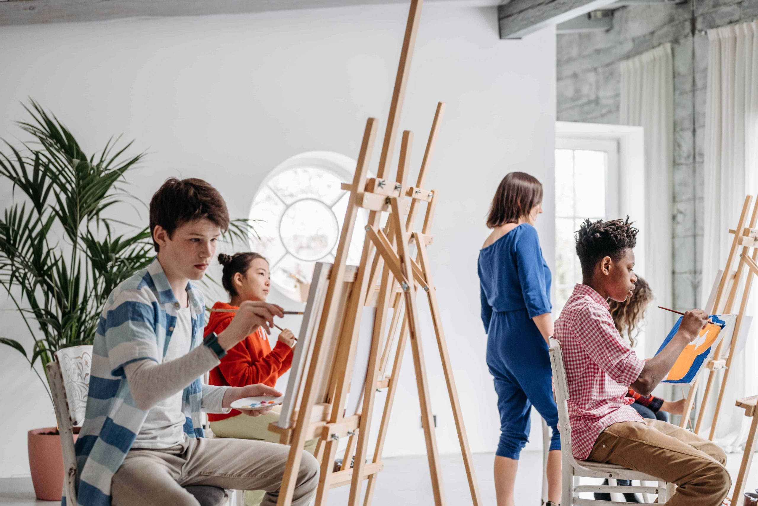 children painting on canvass