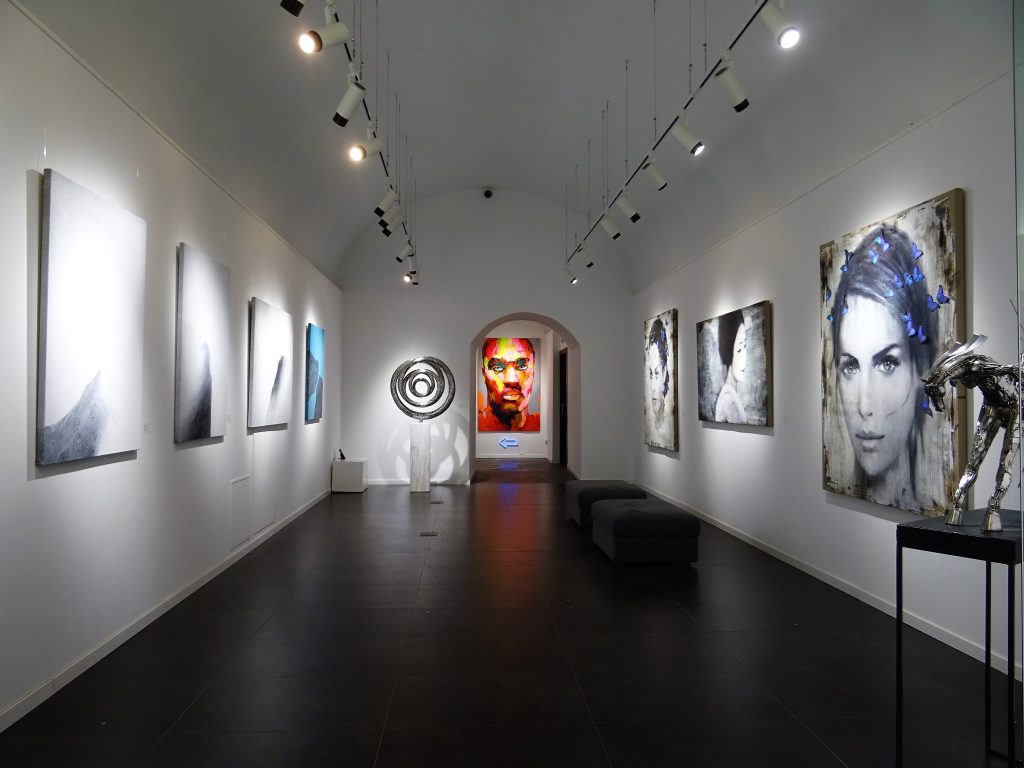 paintings displayed on white wall