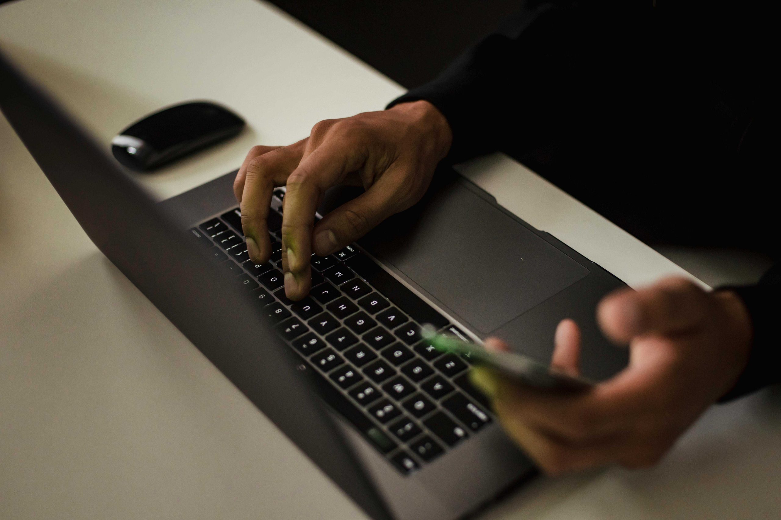hand with laptop and phone