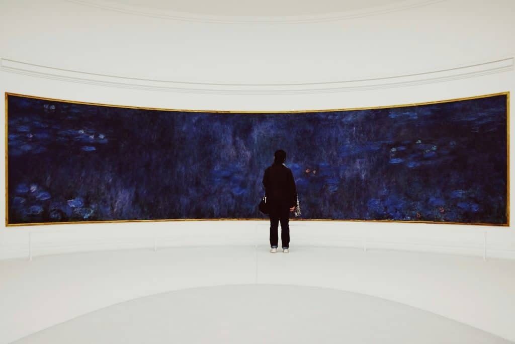 man standing in front of an art