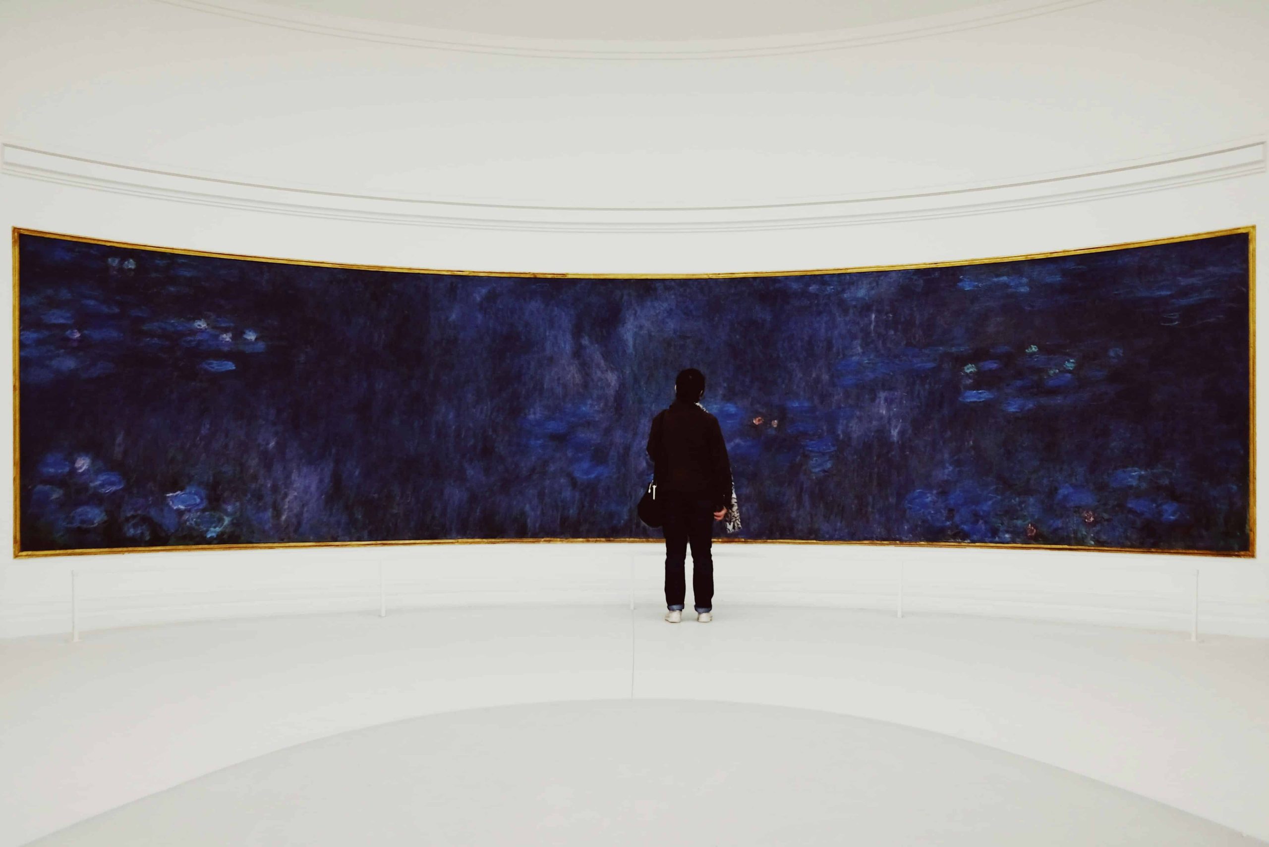 man standing in front of an art