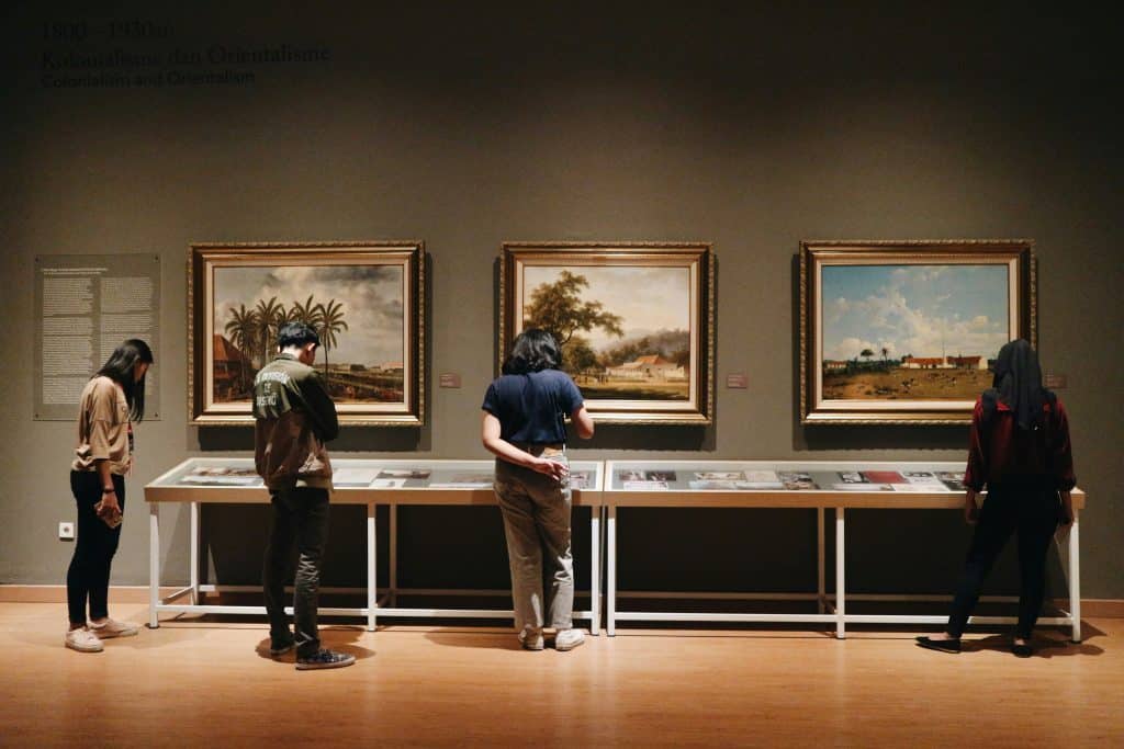 people looking on paintings