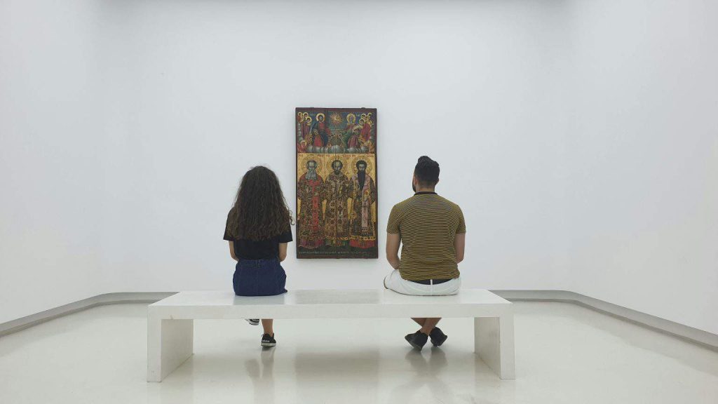 man and girl looking at the painting