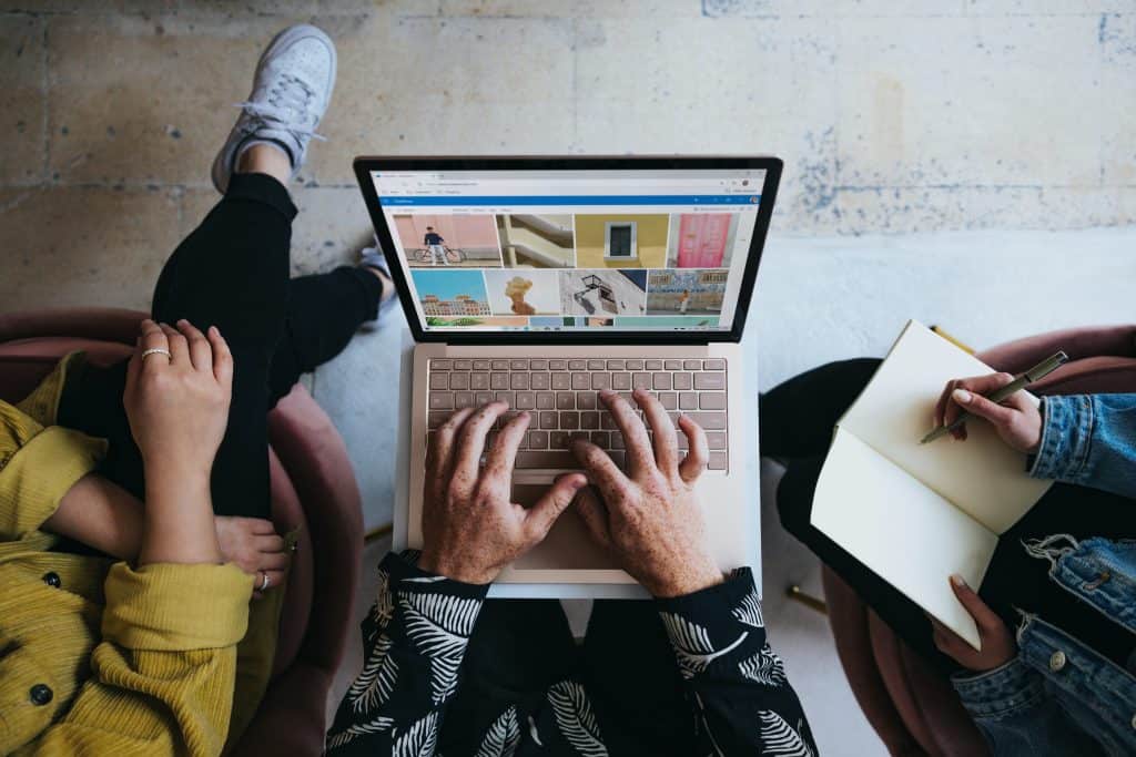 writing and designing on laptop