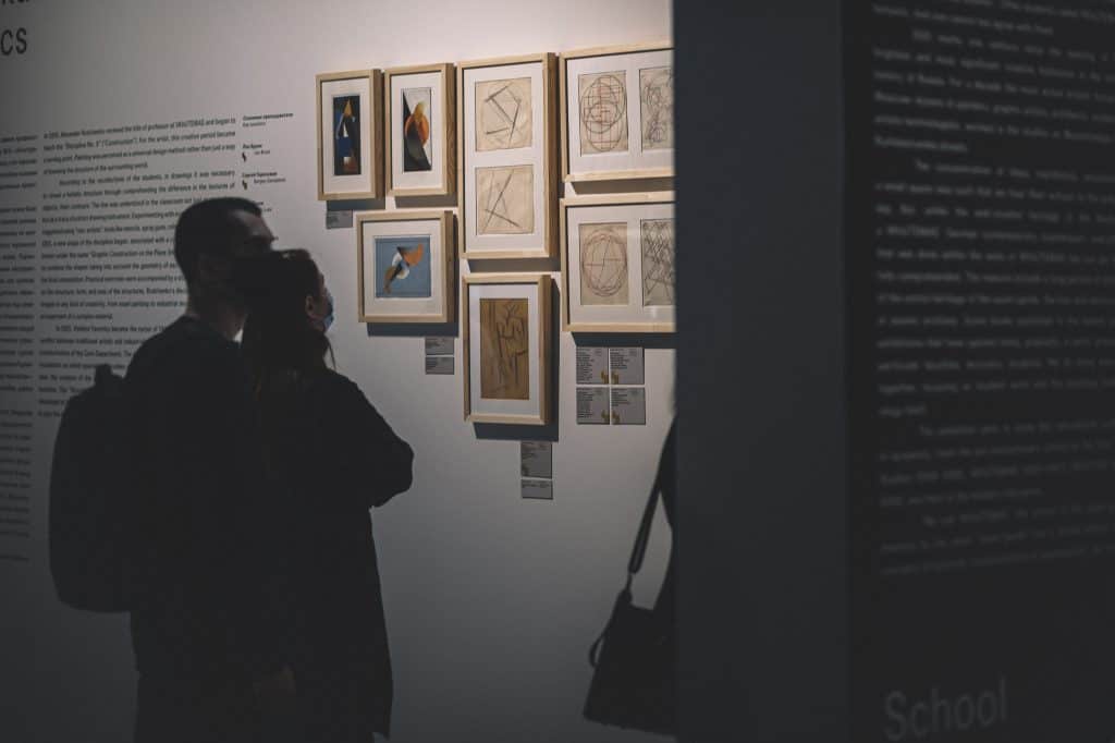 people looking on paintings