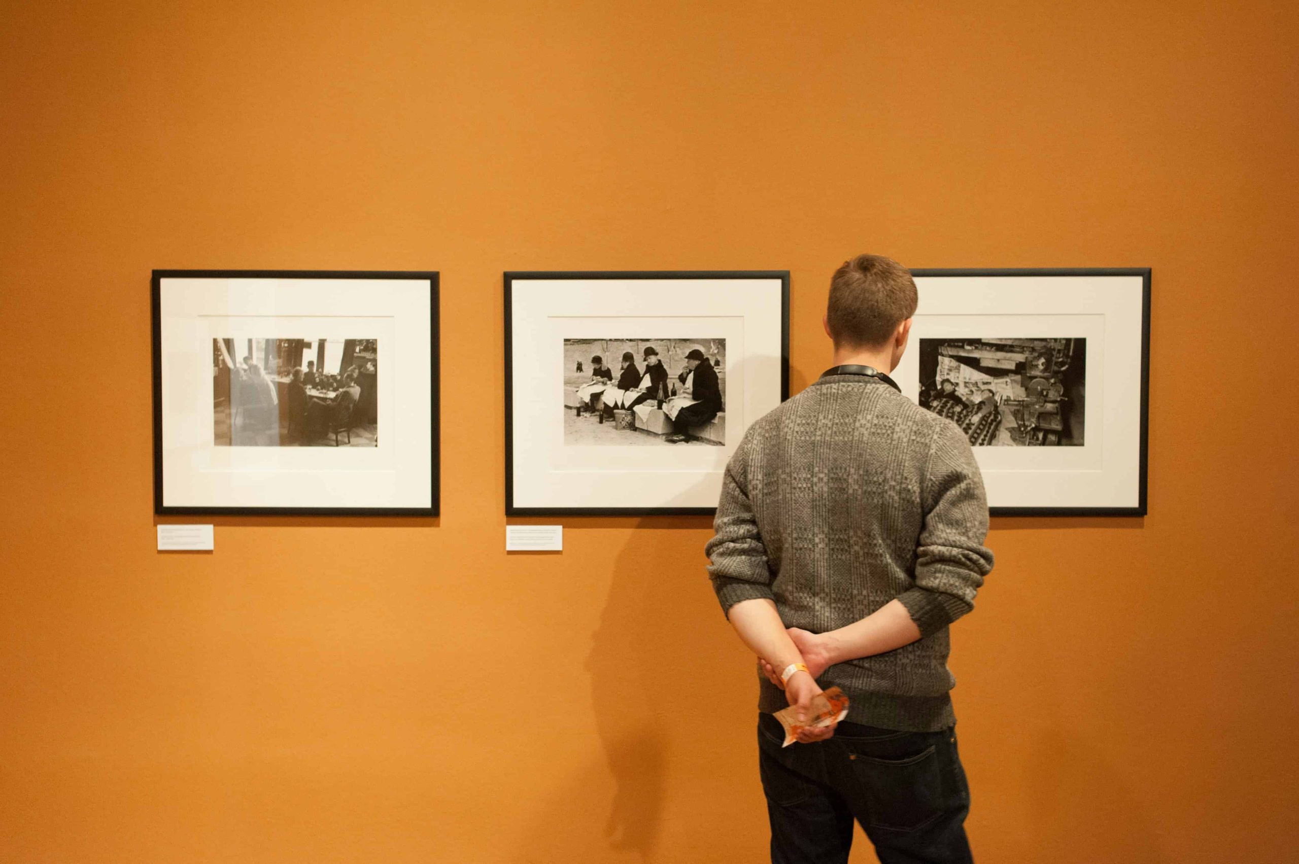 men looking on paintings