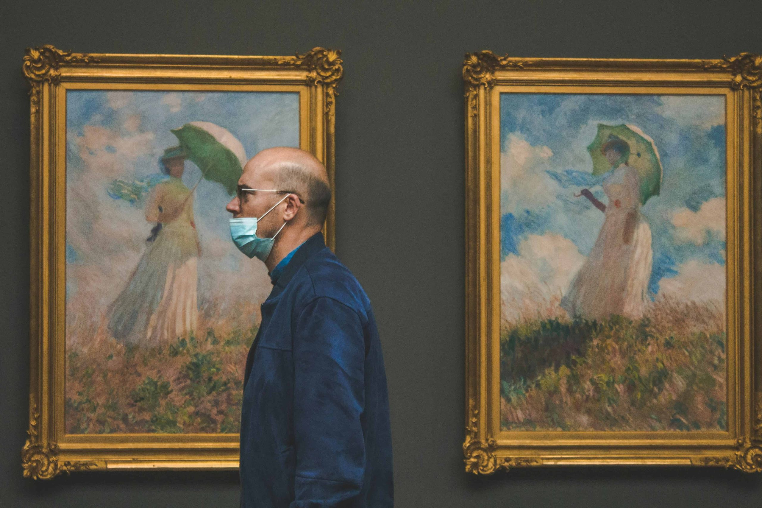 men standing in front of paintings