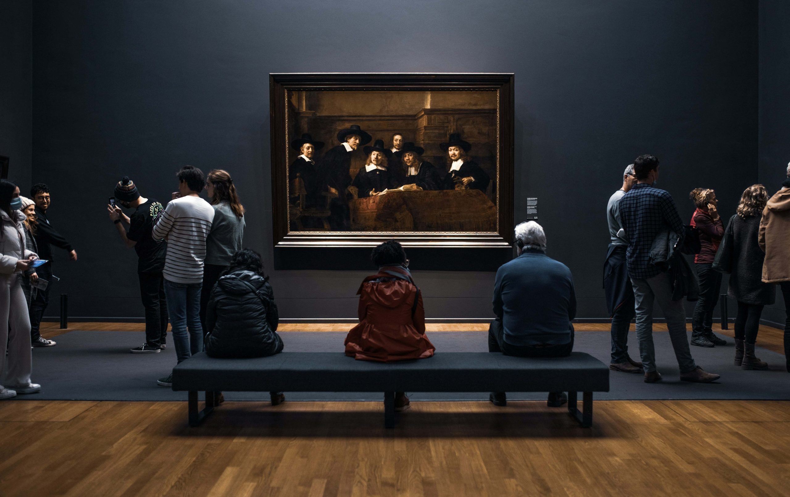 people looking on the paiting